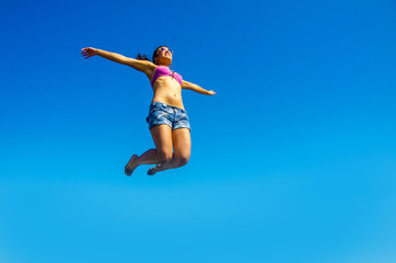 Obraz premium Girl is jumping in the air