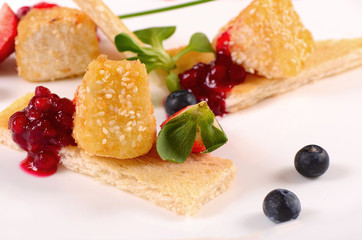 Cheese in breadcrumbs with currant jam