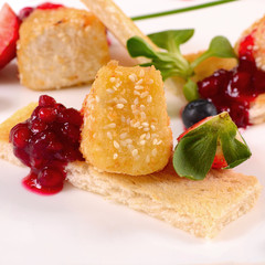 Cheese in breadcrumbs with currant jam