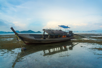 Longtail boat at low tide