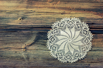 Old boards covered with handmade crocheted doily