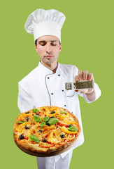 Studio portrait of a chef seasoning pizza with oregano