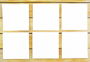 White sheets of paper on a background of wooden slats