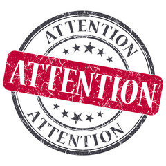 Attention red round grungy stamp isolated on white background