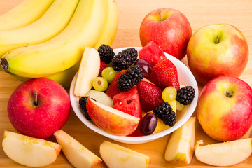 Cut Fruit in Bowl with Bananas and Whole and Cut Apples
