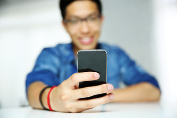 Closeup portrait of a man using smartphone. Focus on smartphone.