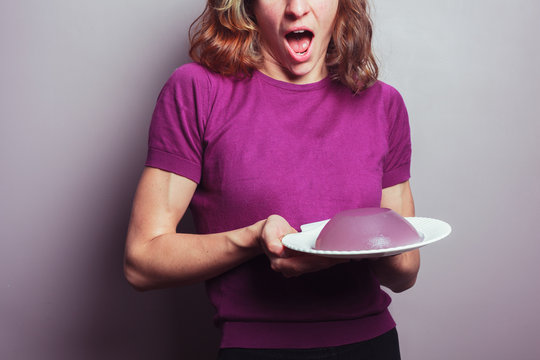 Excited young woman with pudding