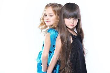 portrait of two beautiful young girlfriends in studio