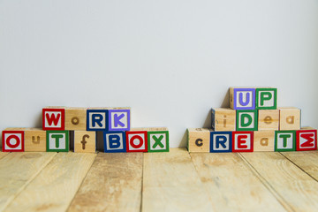 Wooden block create idea word on wooden floor2