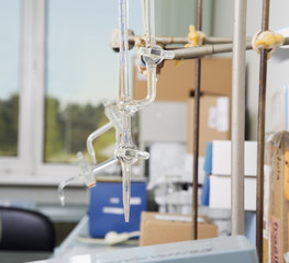 Laboratory holder for pipettes against a window .