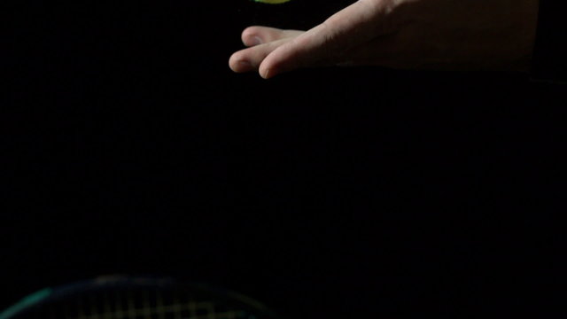 Tennis serve against black background