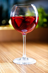 Glass of red wine with fruits