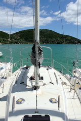 deck of sailing yacht at sea with islands and mountains