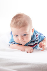 Close-up of a baby boy lying on the bed