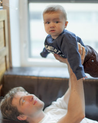 Man playing with his baby son