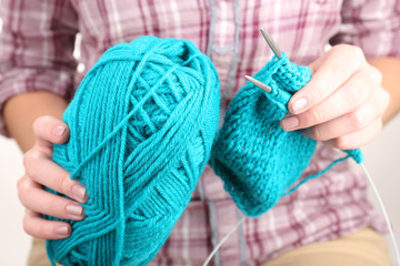 Female hands knitting with spokes close up