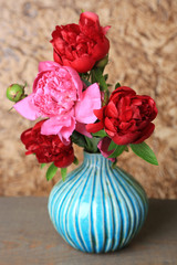 Beautiful pink peonies on brown wall background