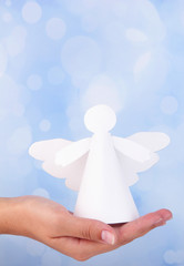 Obraz premium Christmas angel in hand on bright background