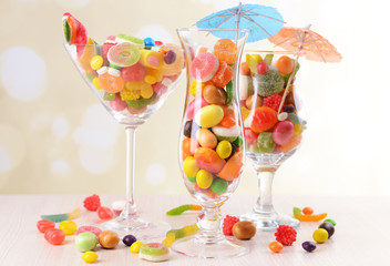 Different colorful fruit candy in glasses