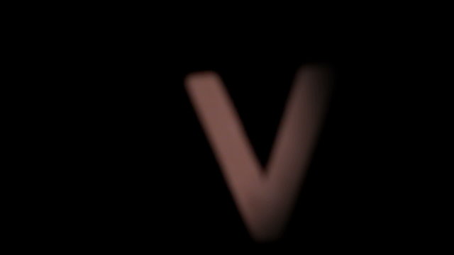 The letter v rising on black background