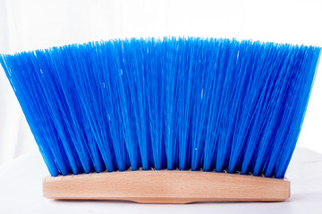 Wooden blue brush for cleaning a floor isolated on a white