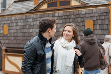 Couple Looking At Each Other Against House