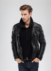 Fashion man, model leather jacket, gray background