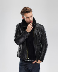Fototapeta premium Fashion man, model leather jacket, gray background