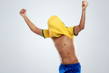 football player with his top over his head for Brazil worldcup © Daxiao Productions