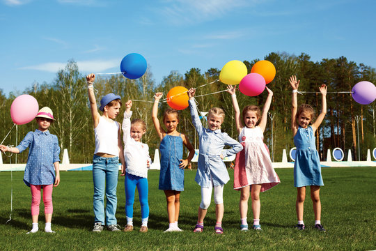 Big group of happy children with balloons