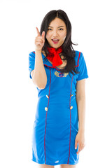 Asian air stewardess pointing up