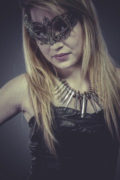 Beautiful blonde with silver jewelry and mask