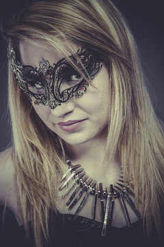 Beauty blonde with silver jewelry and mask