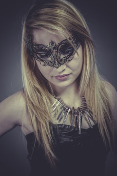 Actress Beautiful blonde with silver jewelry and mask