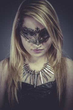 Sexy Beautiful blonde with silver jewelry and mask