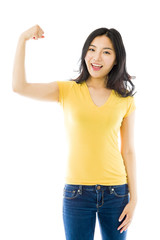 Obraz premium Young Asian woman showing off her muscle