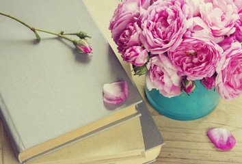 Pink roses in vase,books.Teachers day.Romantic literature.