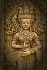 Fototapeta na wymiar Apsara sculptures at Angkor Wat,detail of stone carvings
