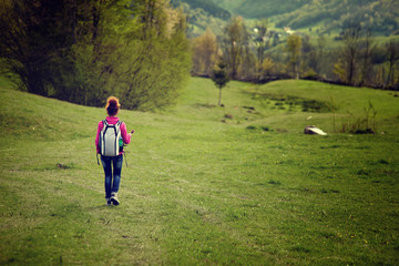 Fototapeta premium Woman hiker on meadow, with copyspace