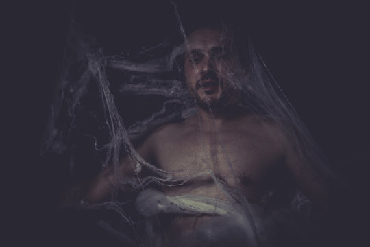 Horror, Man trapped in a spider web