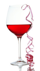 Glass of red wine and streamer after party isolated on white
