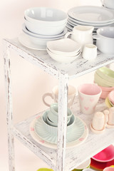Different tableware on shelf, close up