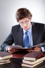 Young businessman reading books