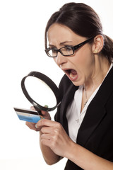 shocked business woman , looking at her credit card