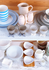 Different tableware on shelf, on wooden background