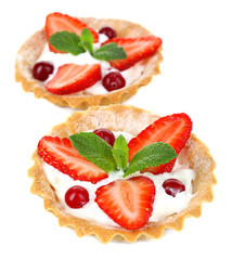 Tasty tartlets with strawberries isolated on white