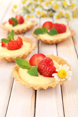 Tasty tartlets with strawberries on table close-up