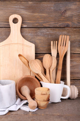 Composition of wooden cutlery, pan, bowl and cutting board