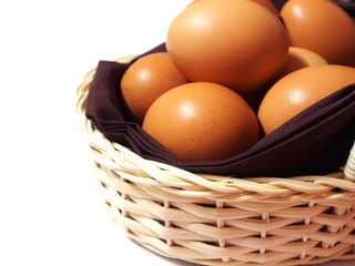 Eggs in a basket isolated on white background