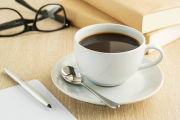 Coffee cup and book on table
